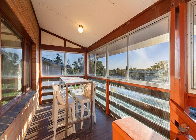 Rear sunroom with dining table and views