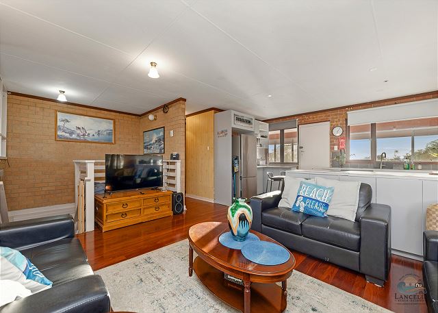 Open-plan living room with TV and couches