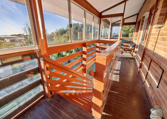 Enclosed balcony with timber railing