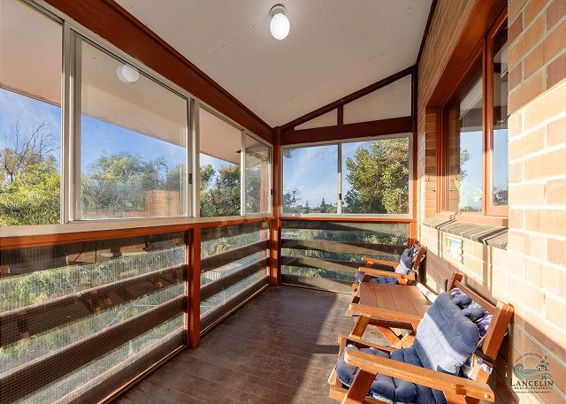 Enclosed rear sunroom with louvre windows