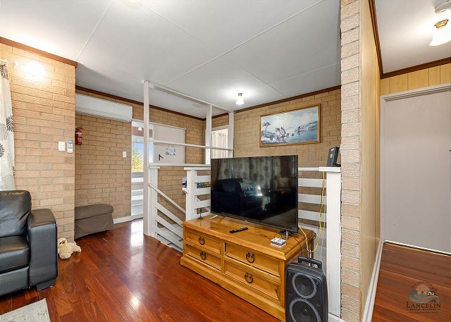 Living area with TV and staircase